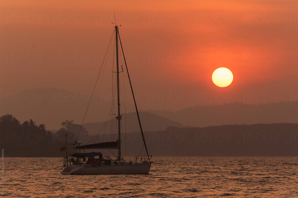 an anchored  yacht in the setting sun