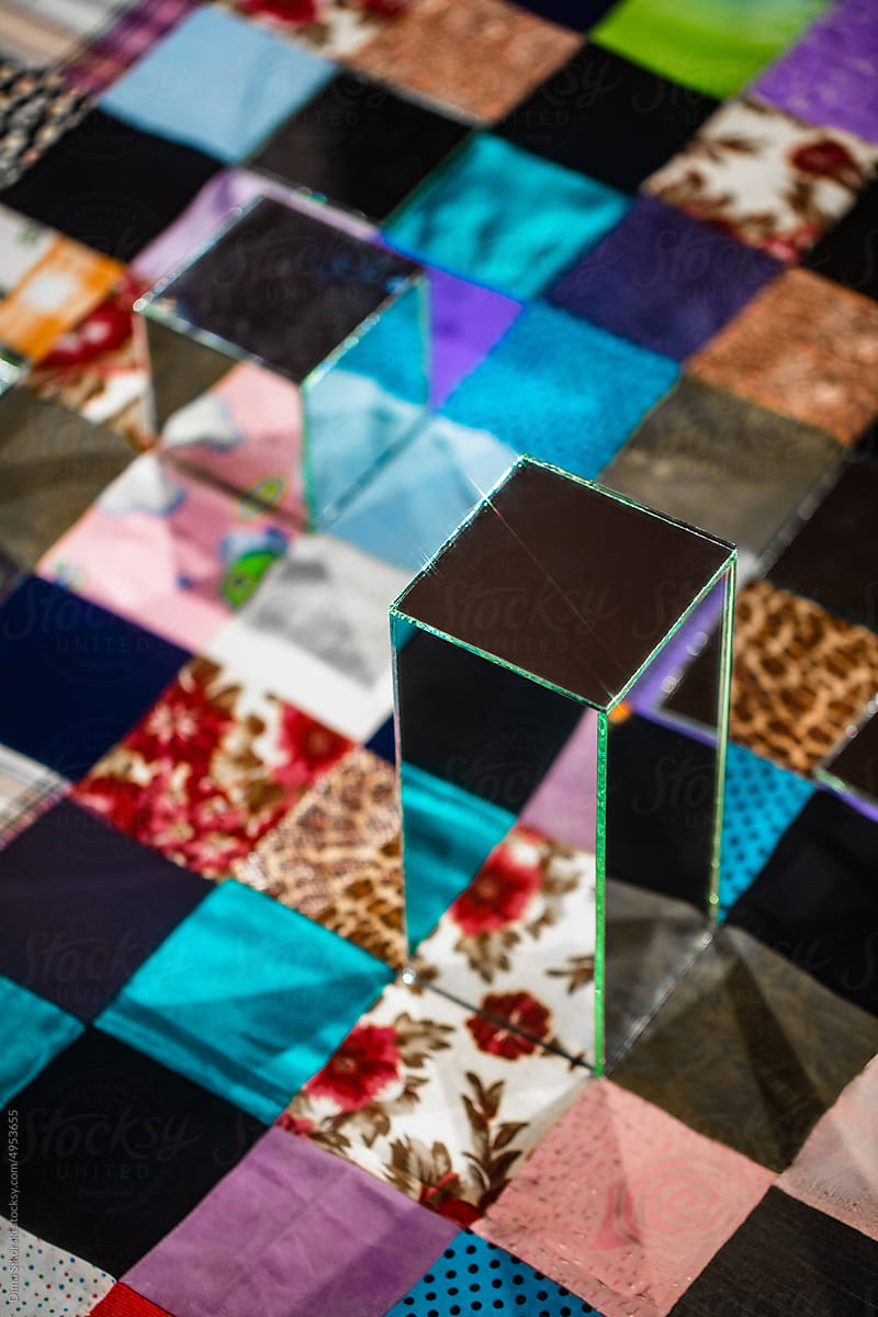 Conceptual still life with patchwork quilt and mirrors