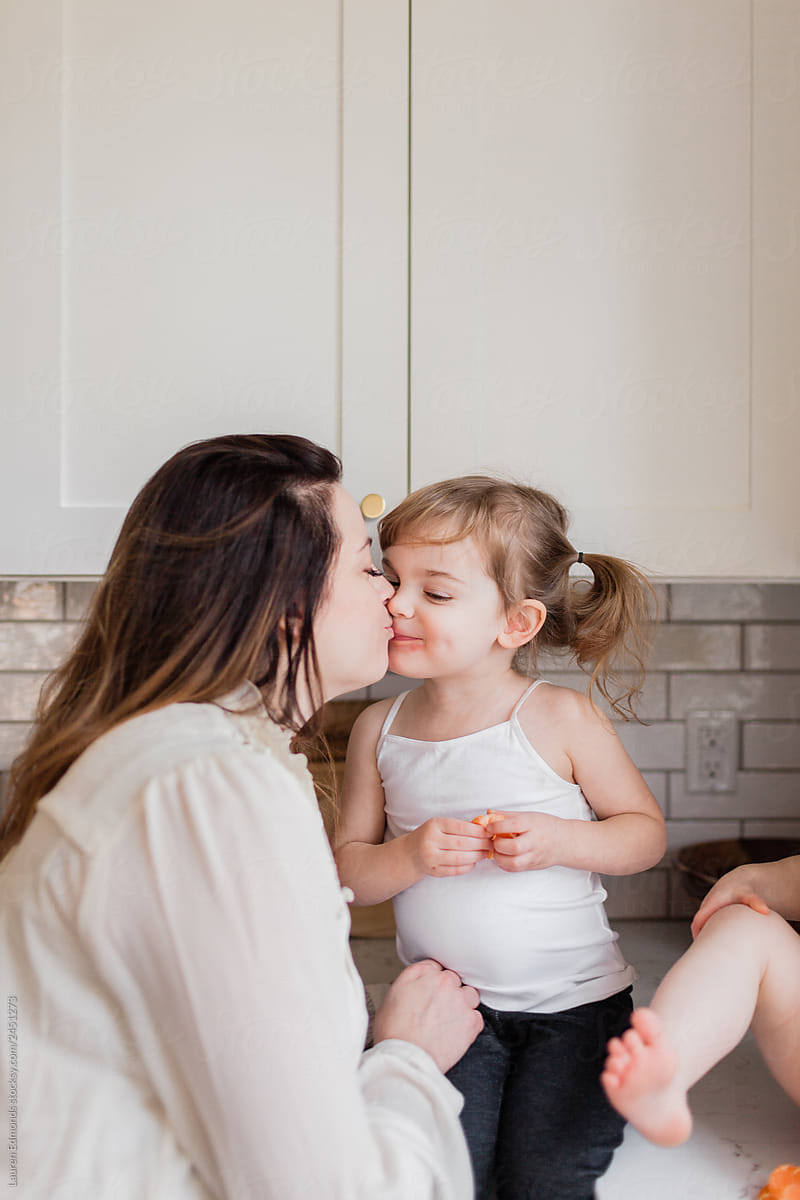 Mother and daughter eating together in kitchen