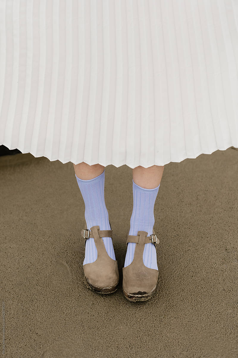 person holding white skirt fanned out with colored socks