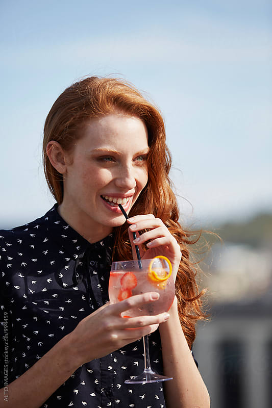 Happy Young Woman Drinking Cocktail