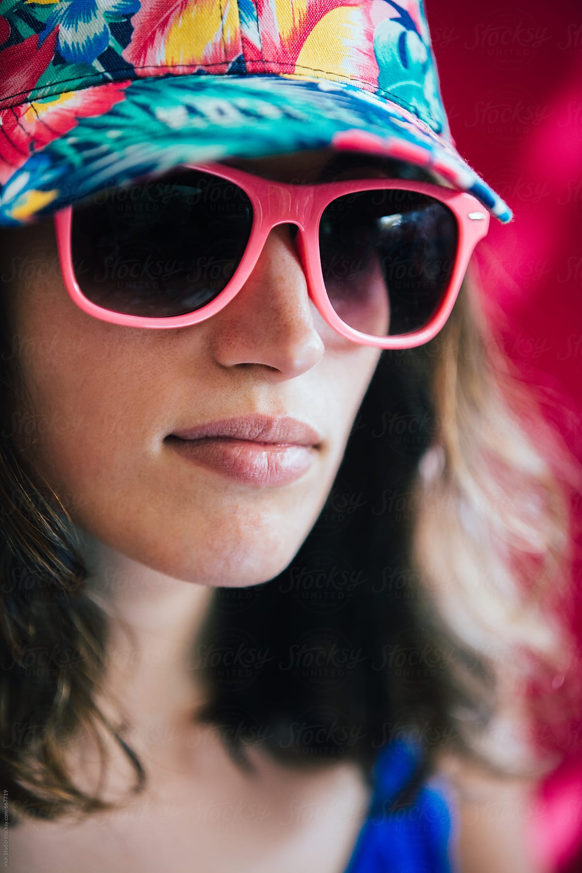 Young Trendy Woman Portrait Wearing Colourful Cap And Pink Sunglasses