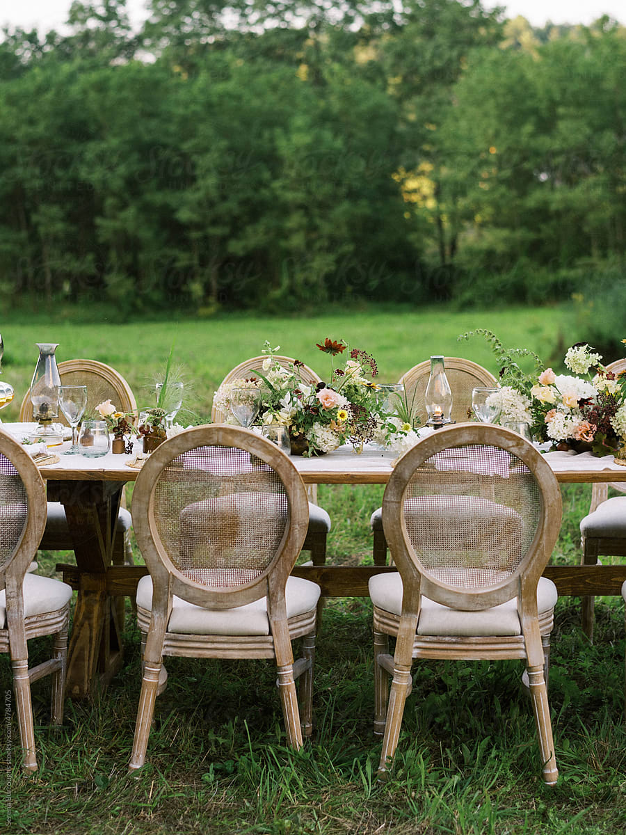 beautiful event table setting amid a green field with a view