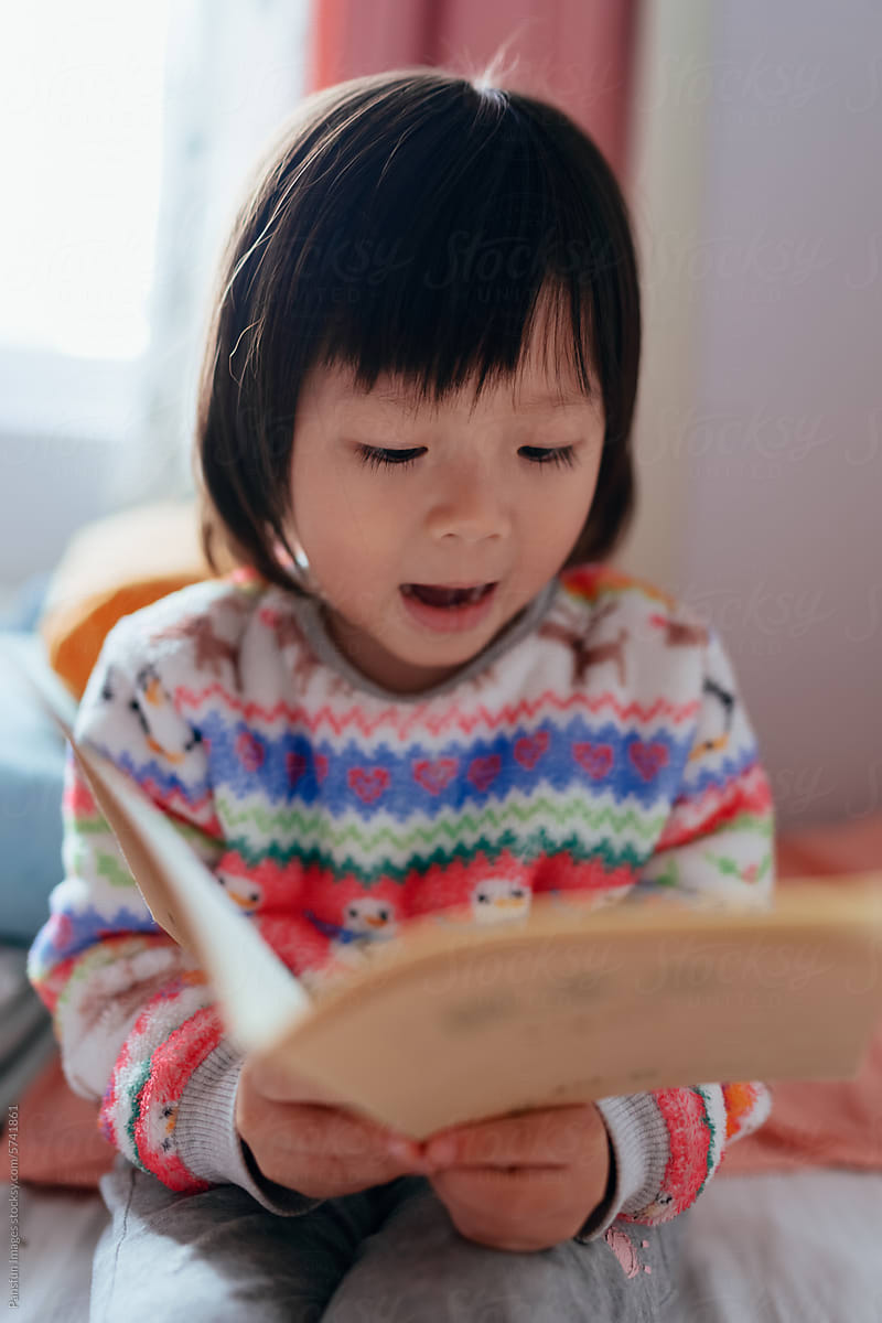 little girl leisurely learning to read