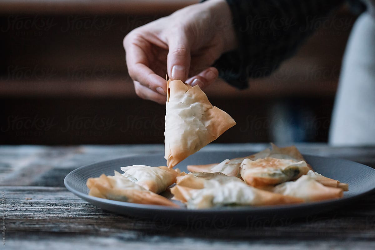 Person with plate filled with spanakopita