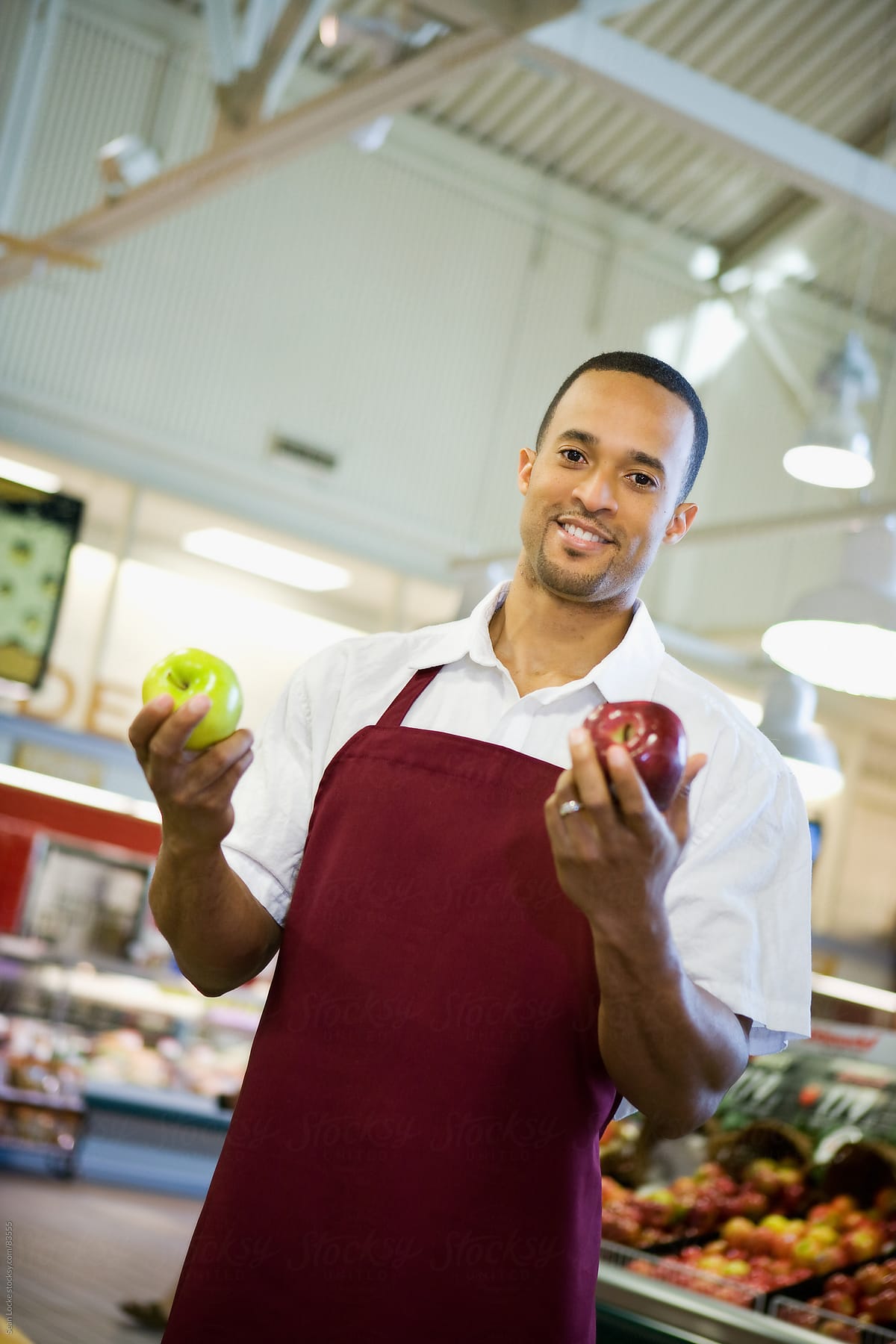 Supermarket: Produce Employee Holding Apples