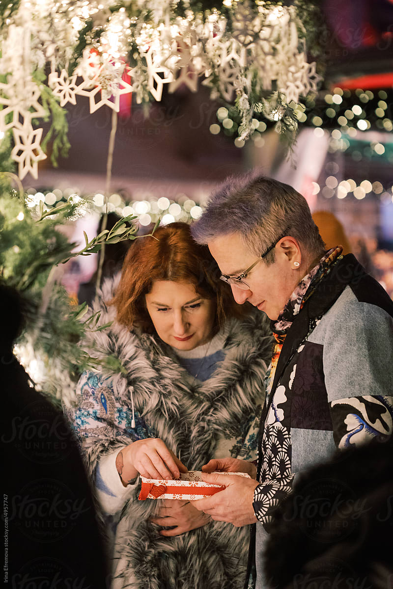 Couple shopping at a Christmas Market for decorations