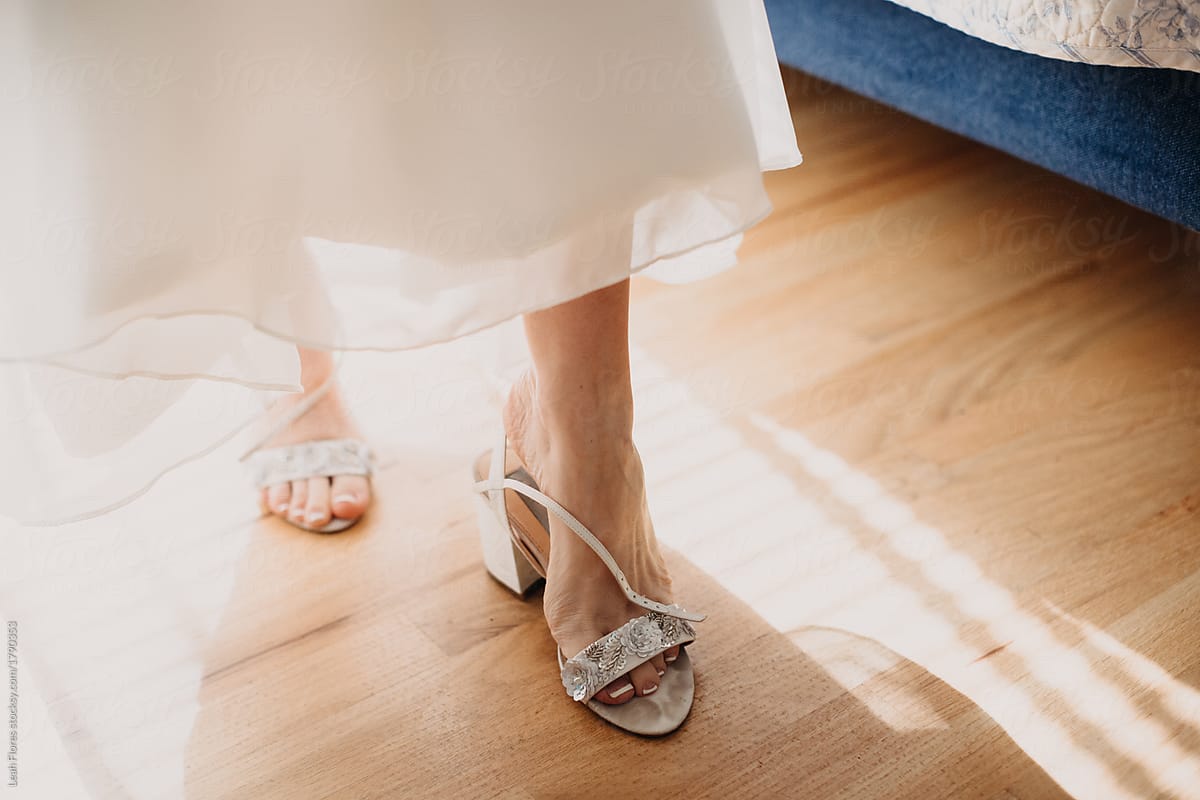 Bride Putting on Shoes Before Wedding