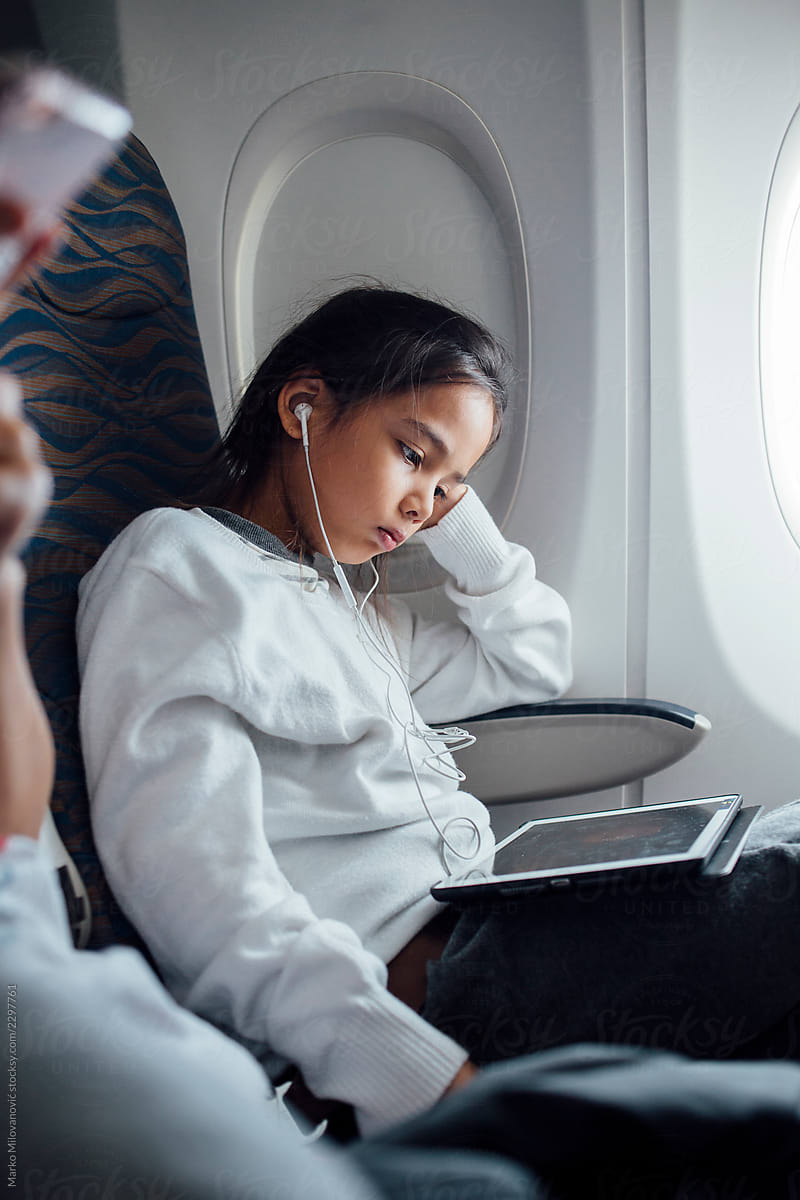 Kid watching a video on a tablet during the flight