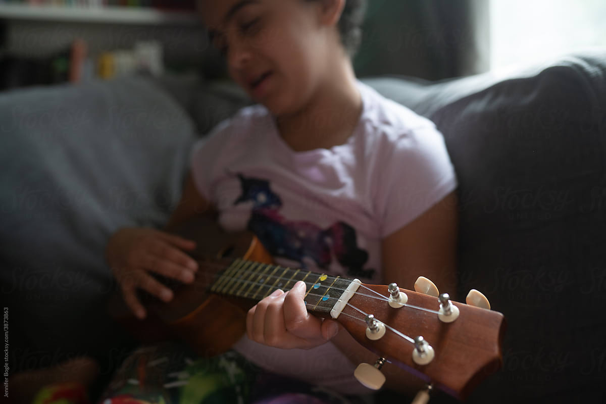 closeup of girl\'s hands on ukulele