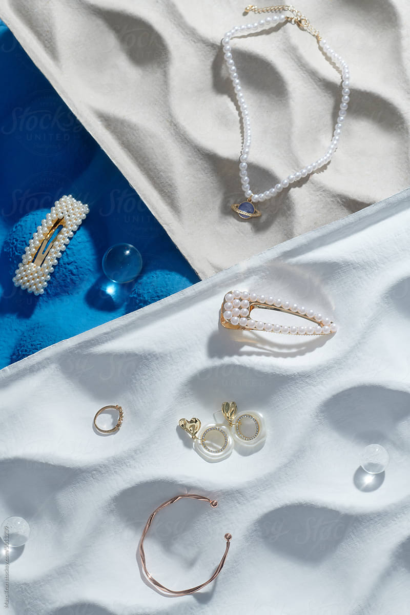 Elegant jewelry trays with beautiful bijouterie on white, flat lay