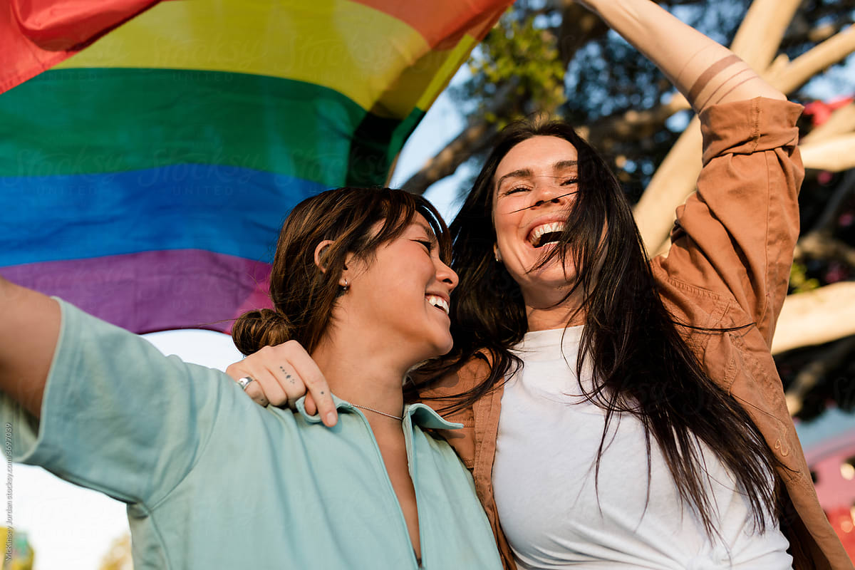 Excited Lesbian Couple Enjoys Each Others Company While Celebrating Pride By Stocksy 