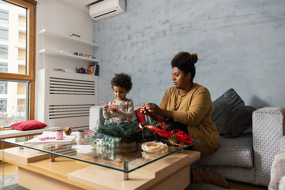 Black Woman And Her Daughter Making Christmas Decoration