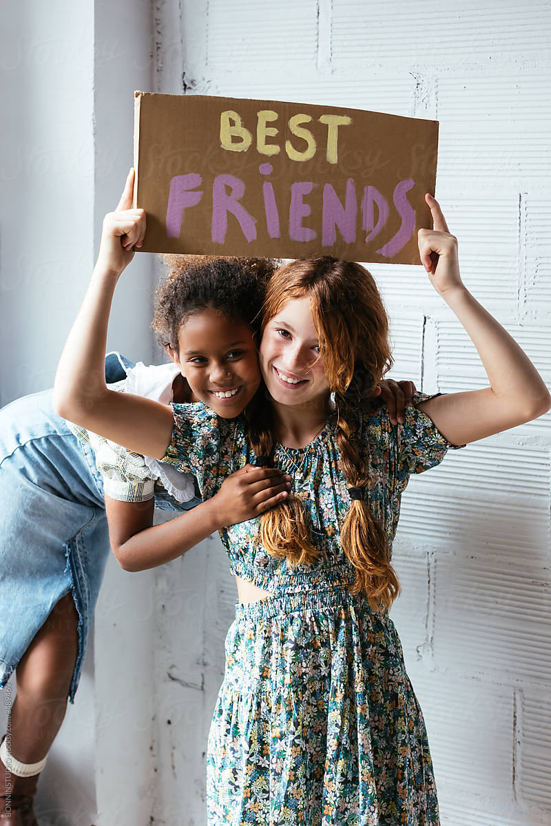 Happy diverse girls with Best Friends banner
