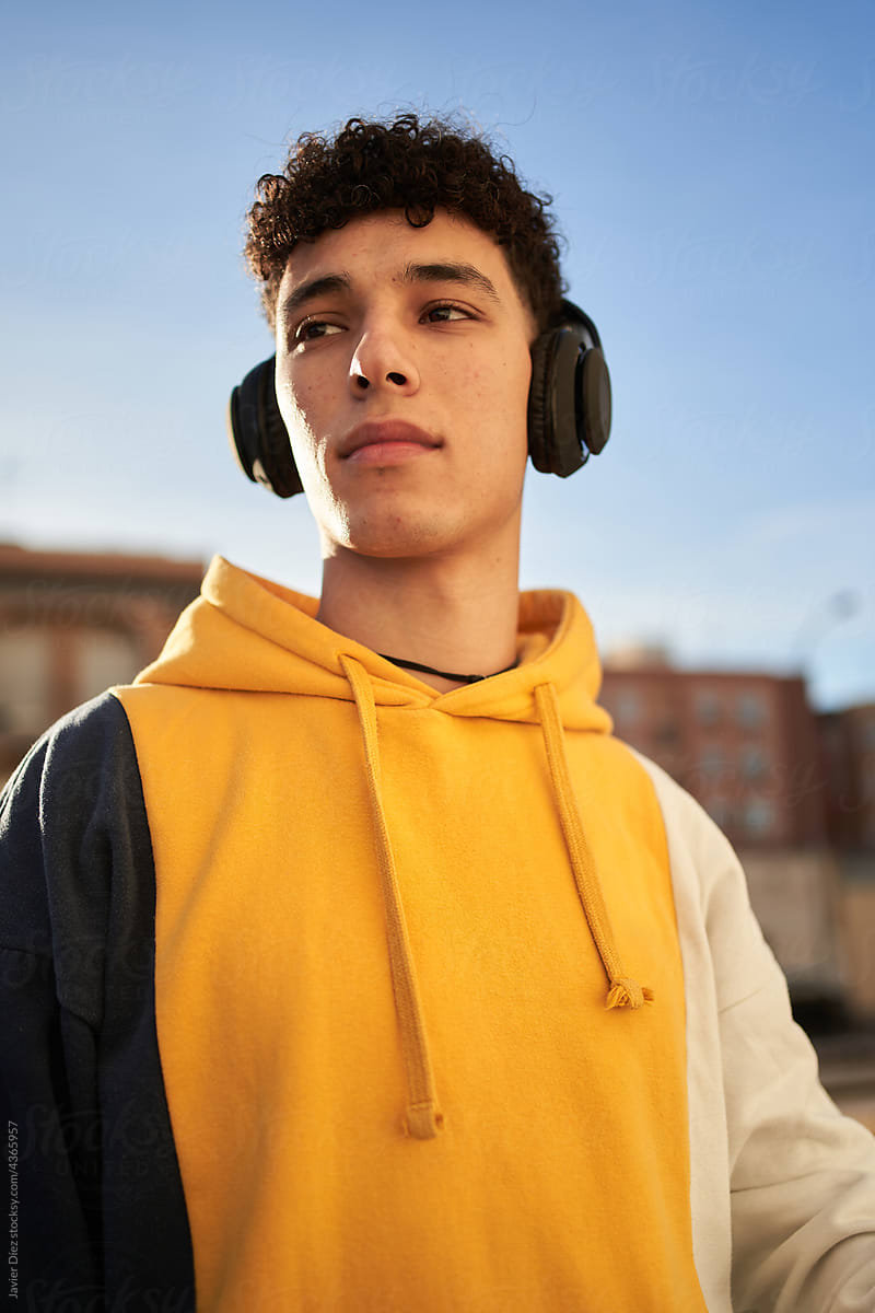 Stylish man using wireless headphones