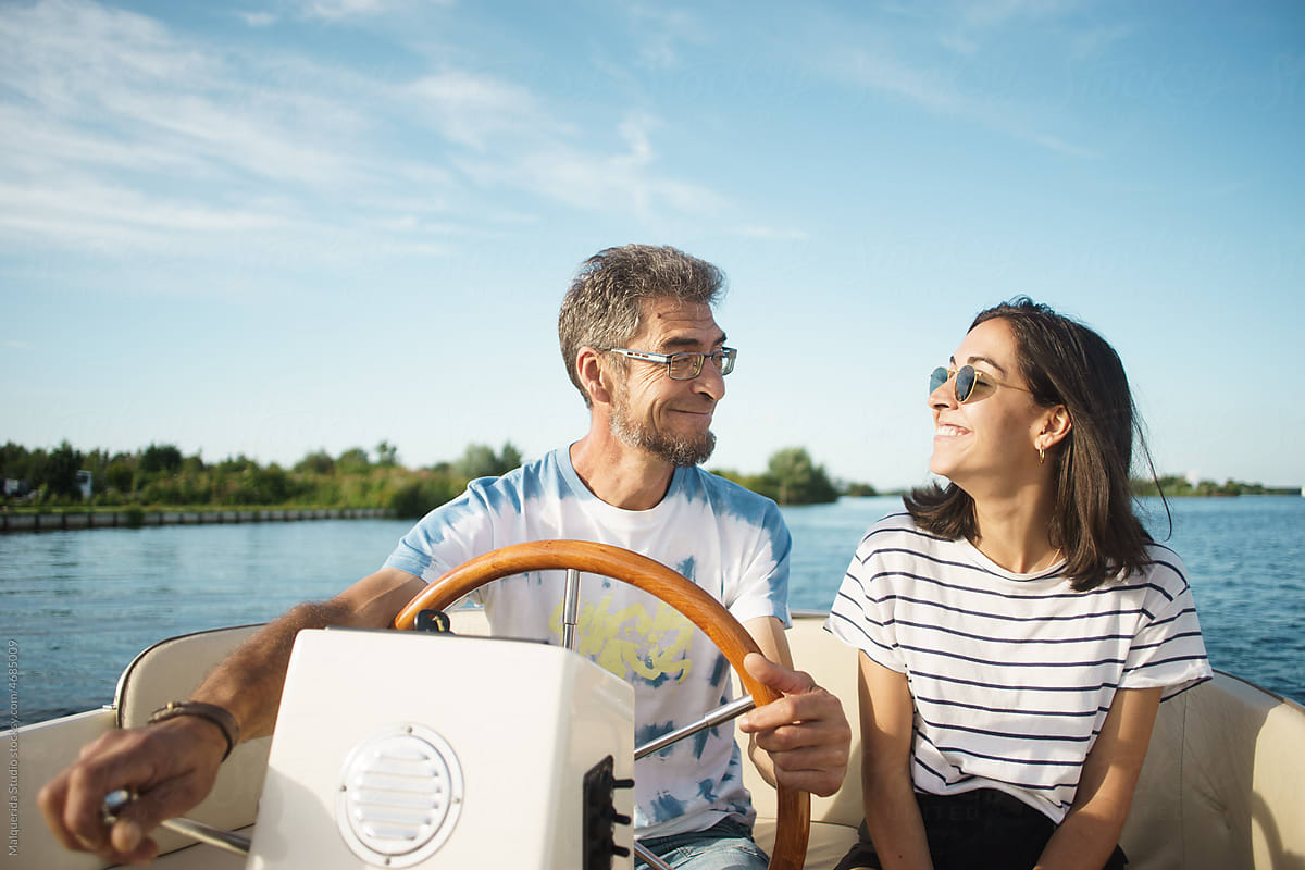 Father and daughter boating on summer