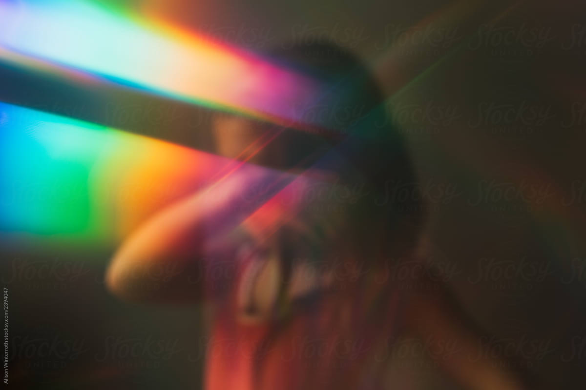 A Child Covering Her Face With A Rainbow