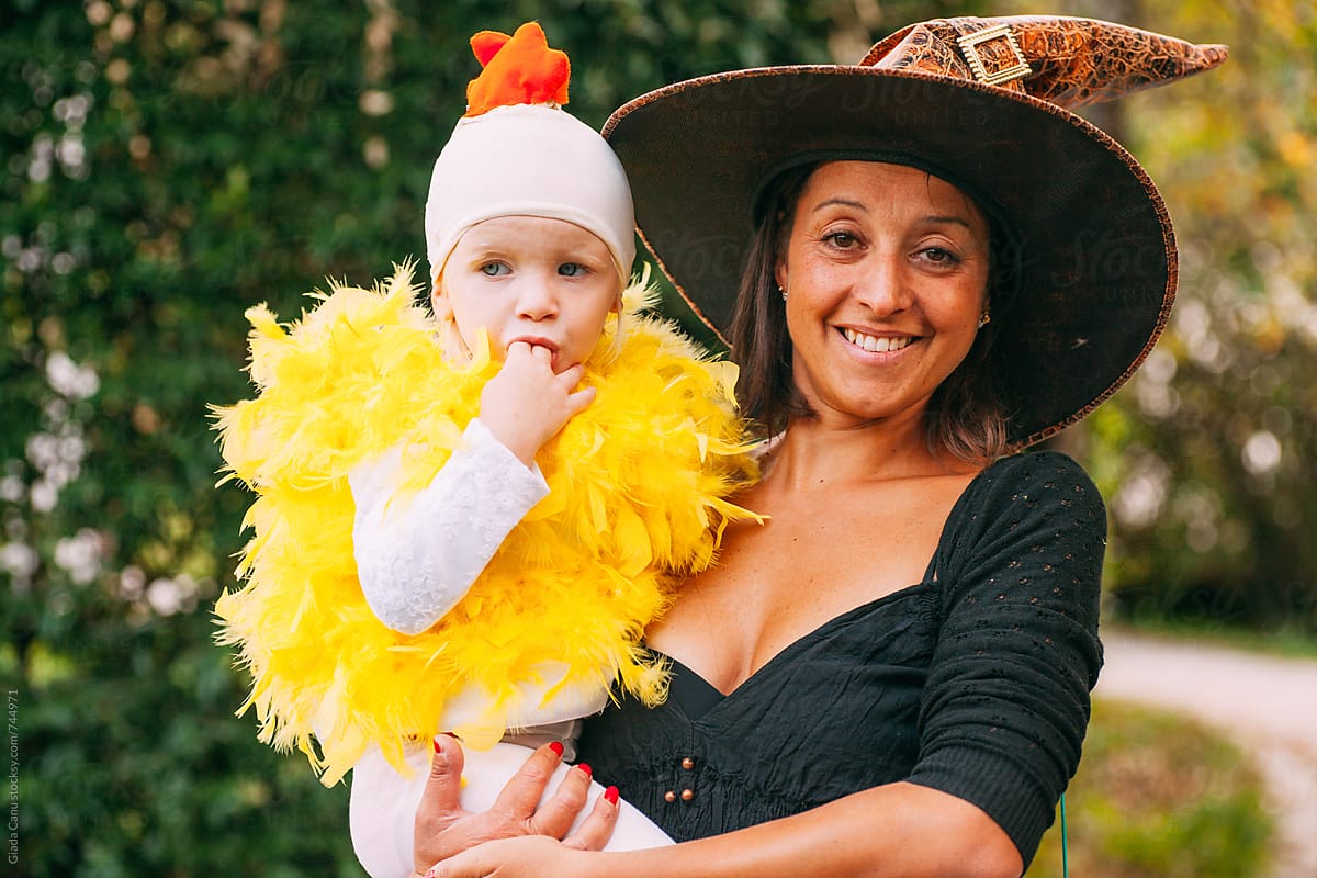 A woman and a toddler dressed as a witch and a chicken