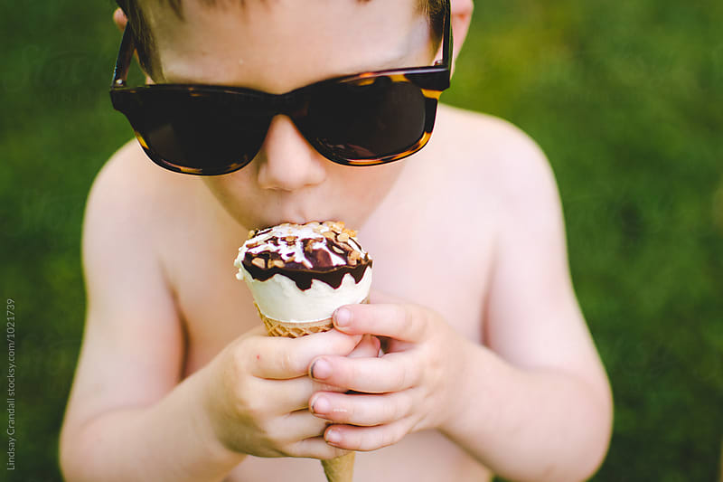 Little boy eating ice cream during summer