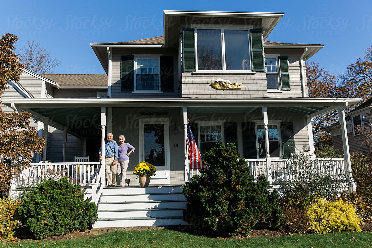 Senior Couple On Porch Of Home Outside By Stocksy Contributor