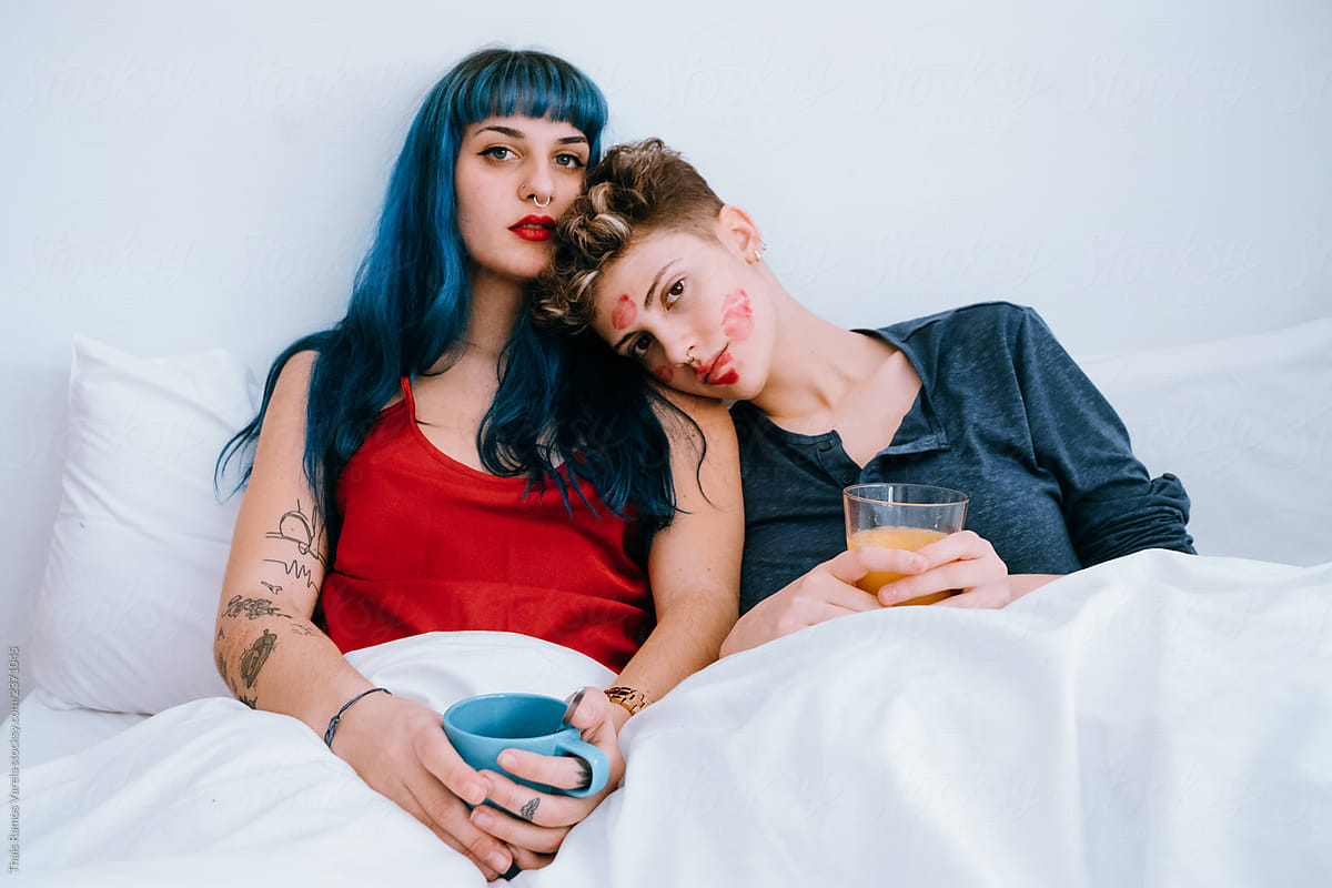 A Couple Of Lesbians In Bed Leave Lipstick Marks On Their Faces By