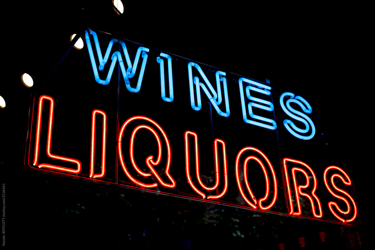 Neon wines and liquor sign lit up at night