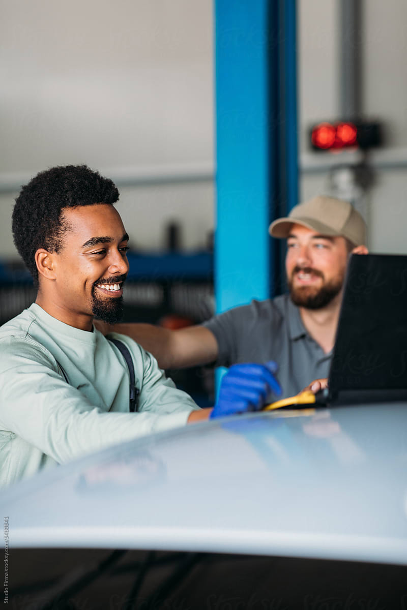 Men Working in Garage, Using Laptop for Diagnostic