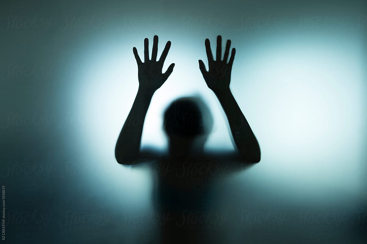 Backlit Figure With Hands Pressed Against Frosted Glass. by RZCREATIVE.