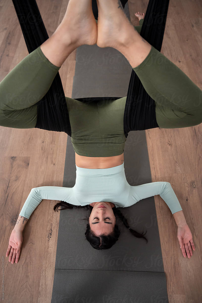 Woman practicing aerial yoga in studio