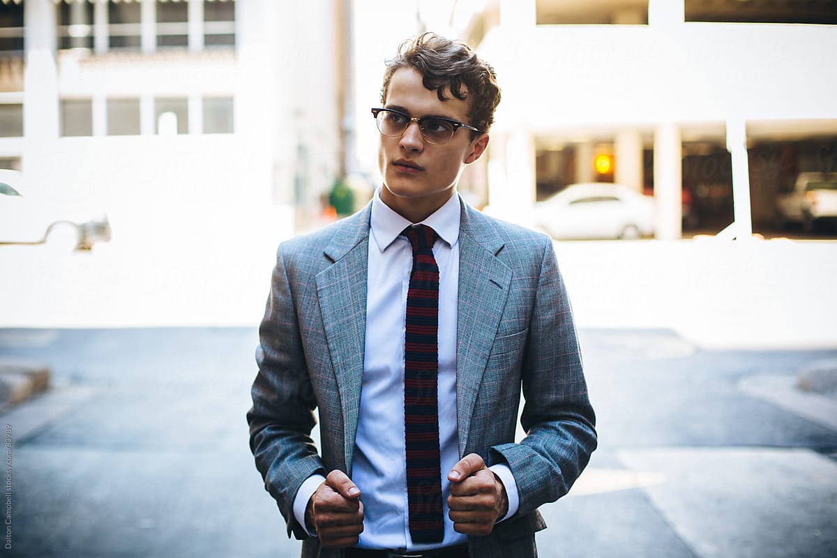 Young Man in a vintage suit traveling around city