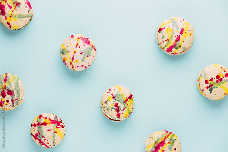 Colour spattered macarons on blue