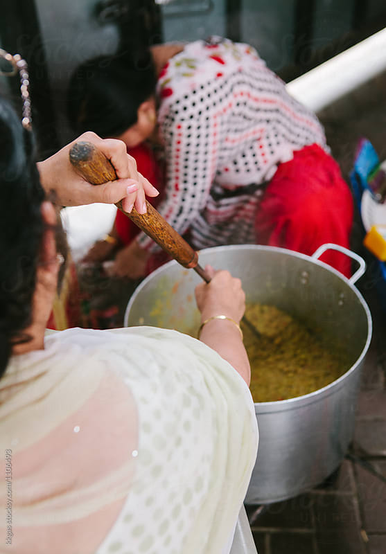 Twp Indian women cooking a large quantity of food