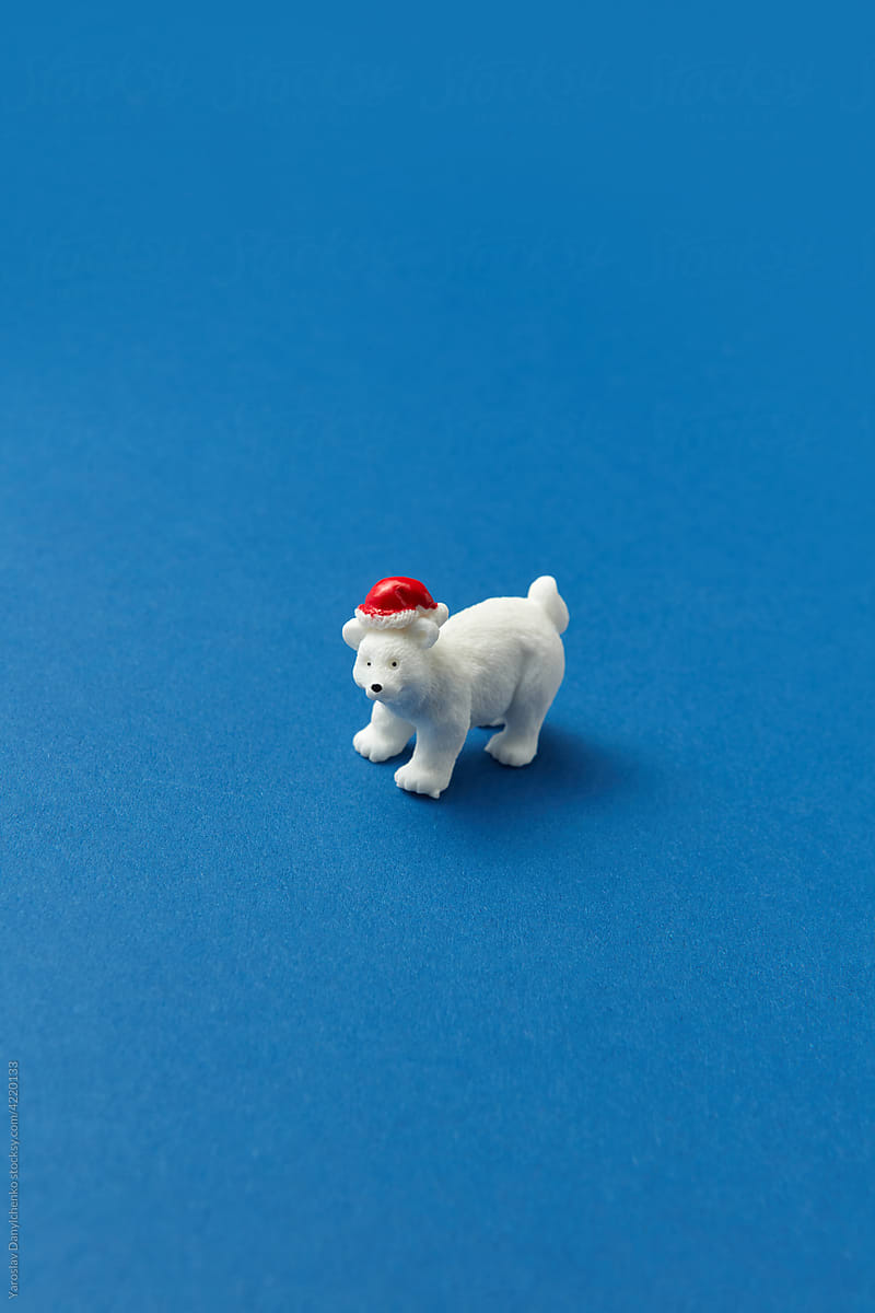Statuette of white bear on blue background