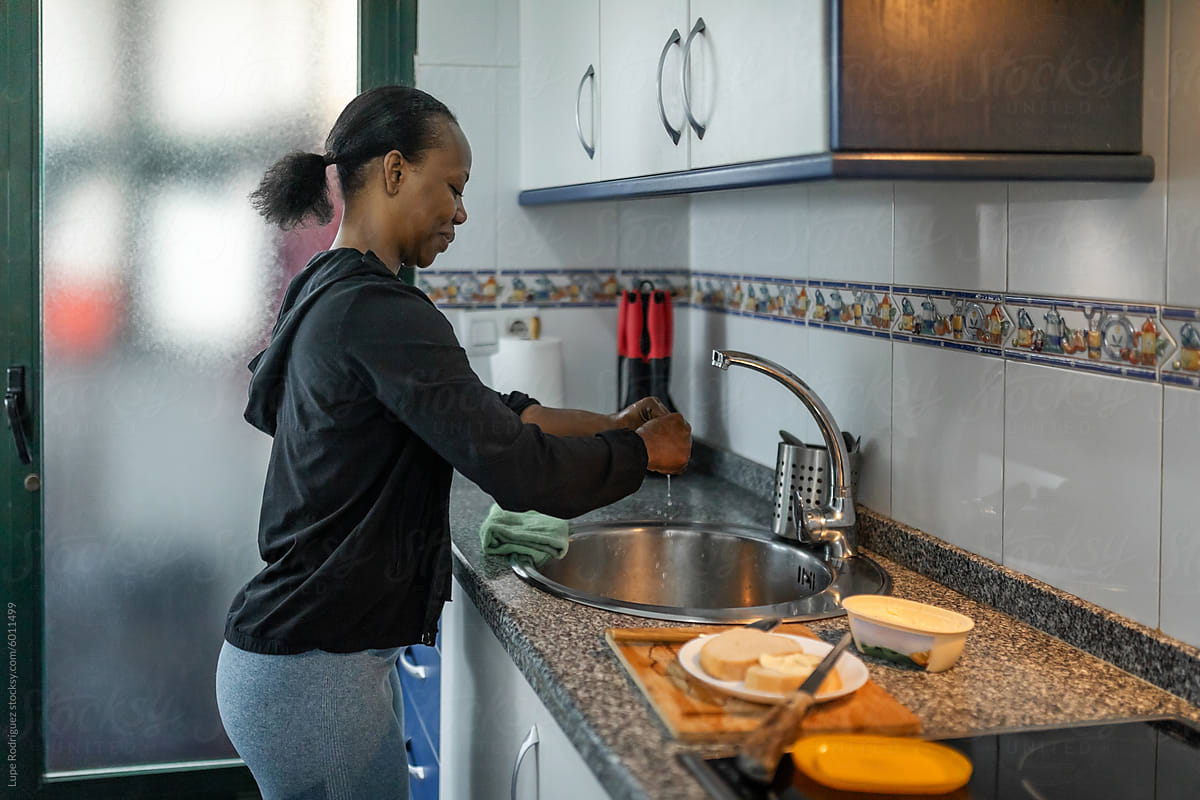 black woman cleaning the kitchen at home
