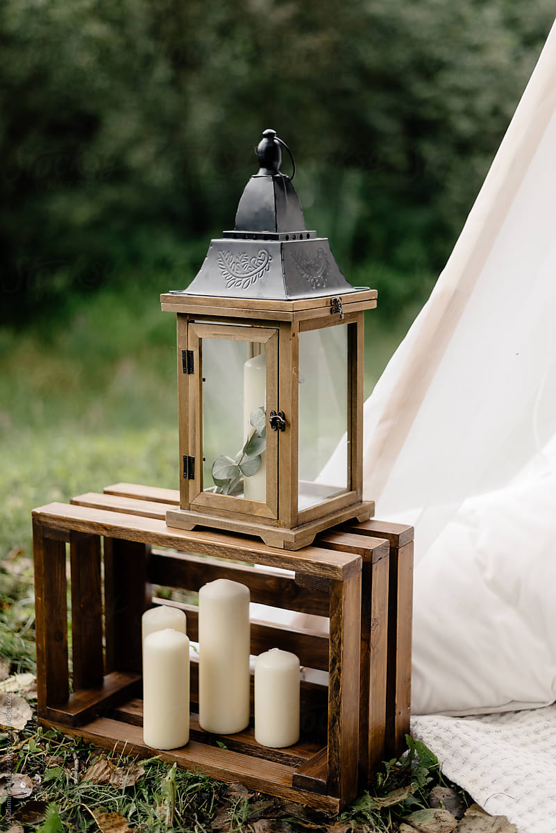 wooden candlestick for wax candles in shape of a lantern