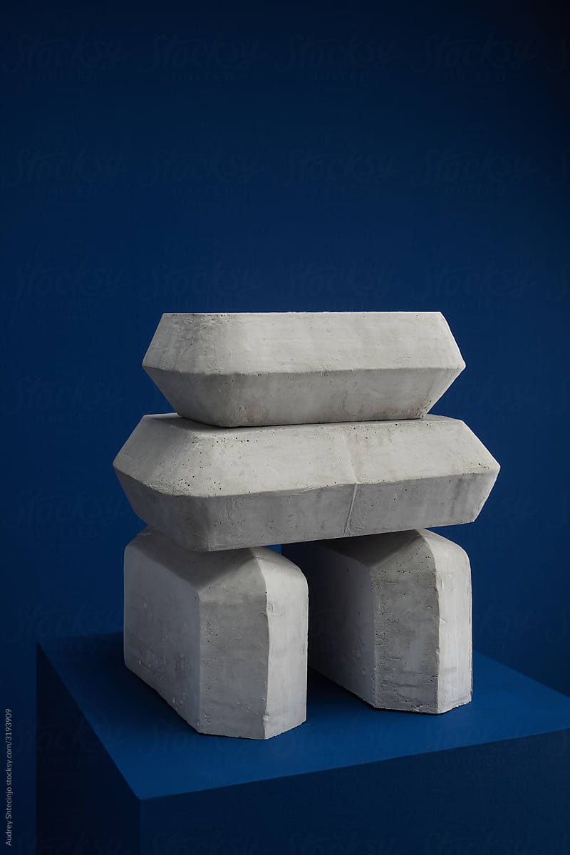 Abstract modernism art sculpture / plaster / stone on dark blue background.