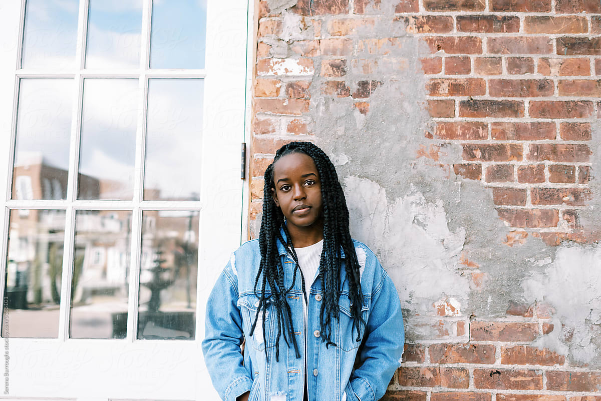 Young beautiful black woman outdoors wearing a jean jacket