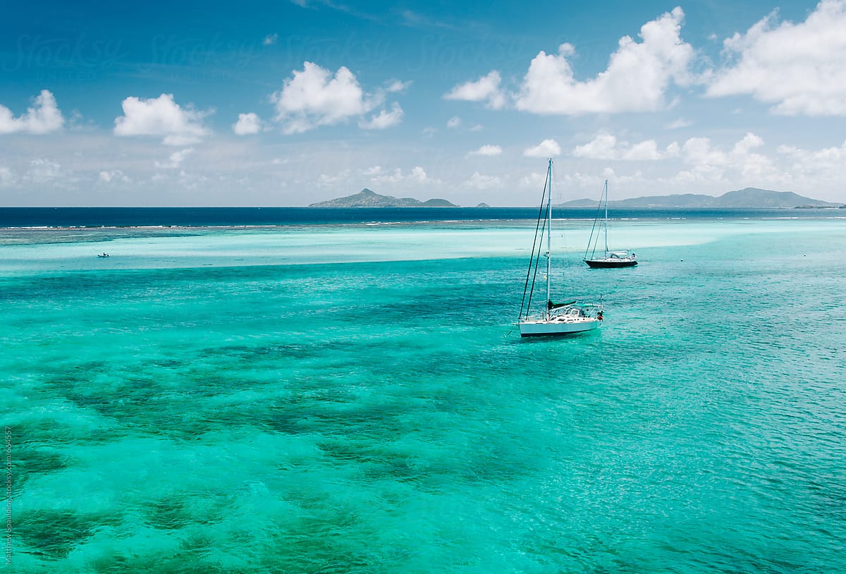 Sailboats anchored in tropical island paradise