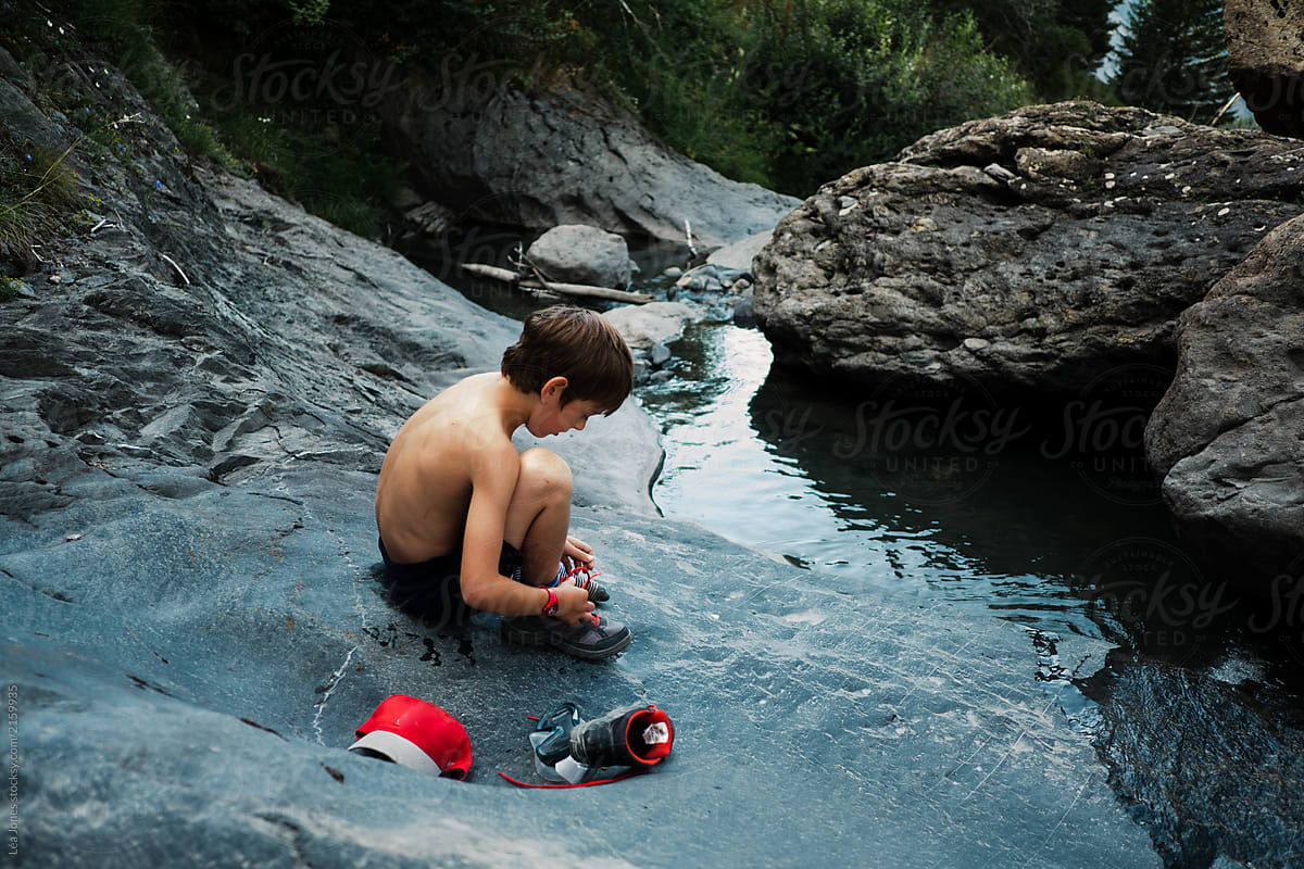  Little Boy Getting Undressed About To Swim In A Stream By Stocksy 