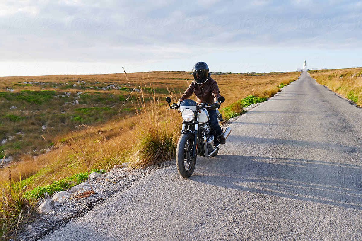 Man riding a motorcycle on a country road