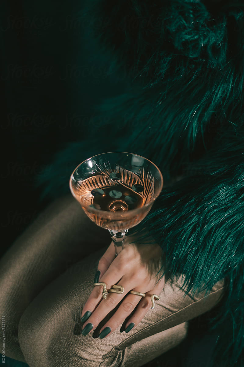 Female hand holding a glass of rose wine