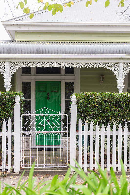 traditional timber cottage with white picket fence