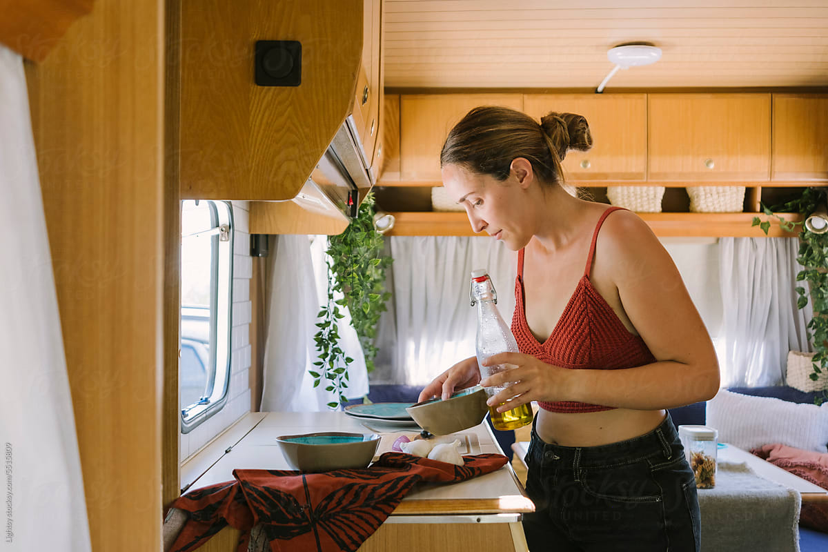 Woman cooking in a caravan