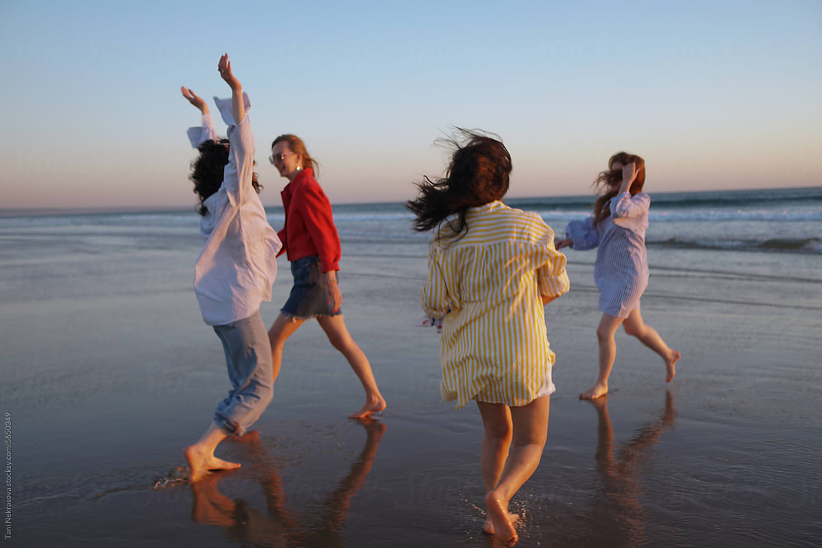 Four young female friends having fun on the seaside. Friendship