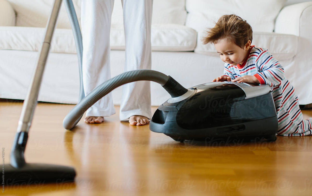 1 year old boy over a vacuum cleaner