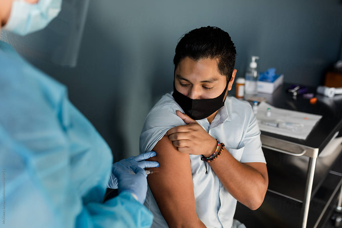 A Young Man Prepares to Receive the Covid-19 Vaccine