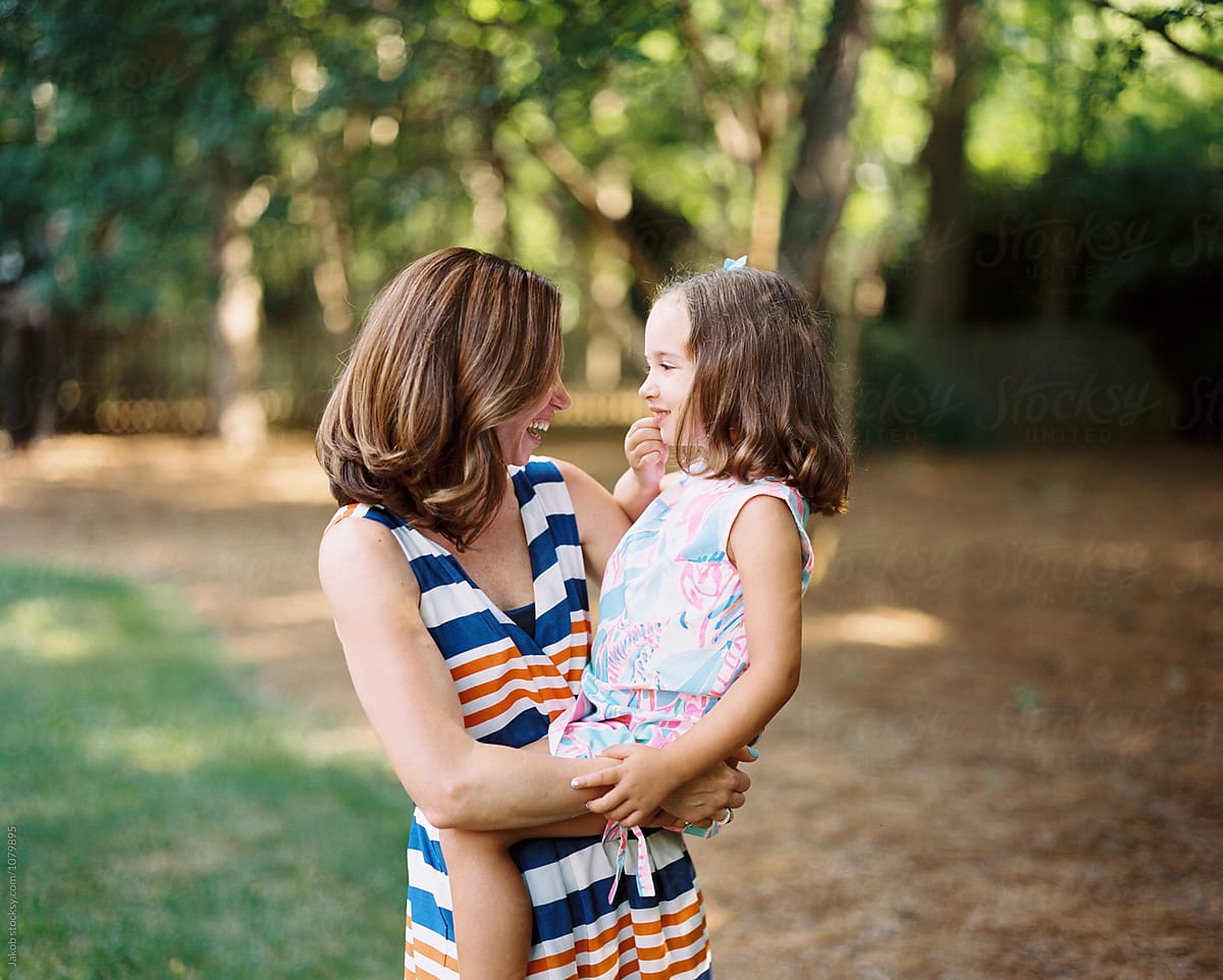 Mother Holding A Beautiful And Playful Daughter By Stocksy Contributor Jakob Lagerstedt