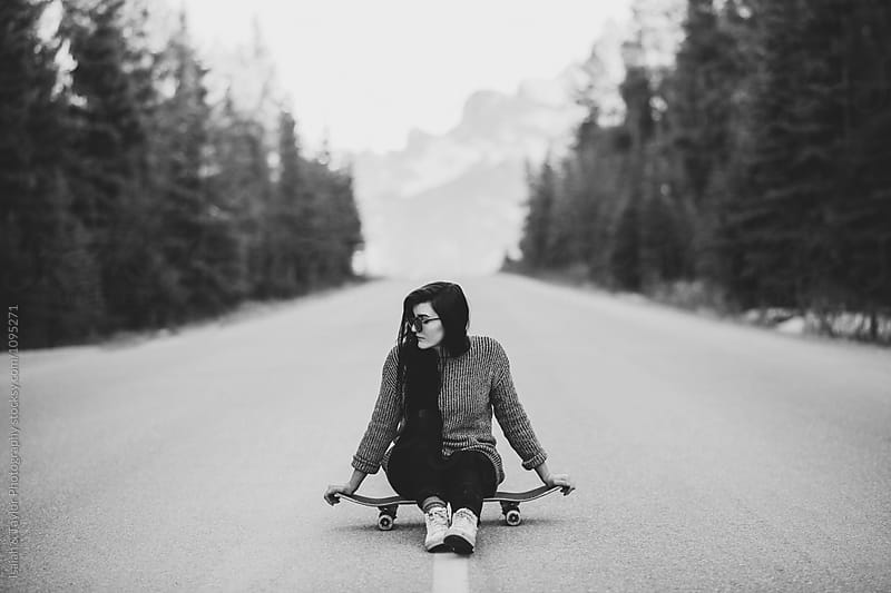 Girl Sitting on Skateboard