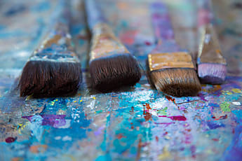 Large Selection Of Paint Brushes And A Mini Paint Palette by Stocksy  Contributor Carolyn Lagattuta - Stocksy