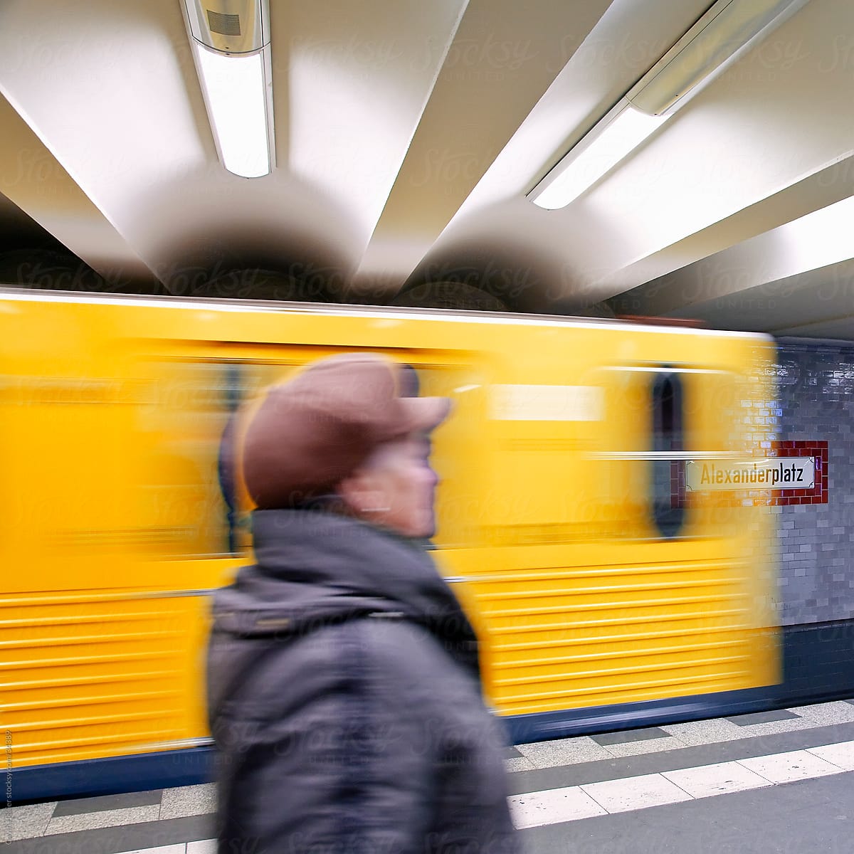 Europe, Germany, Berlin U-Bahn station  - moving train pulling into the station